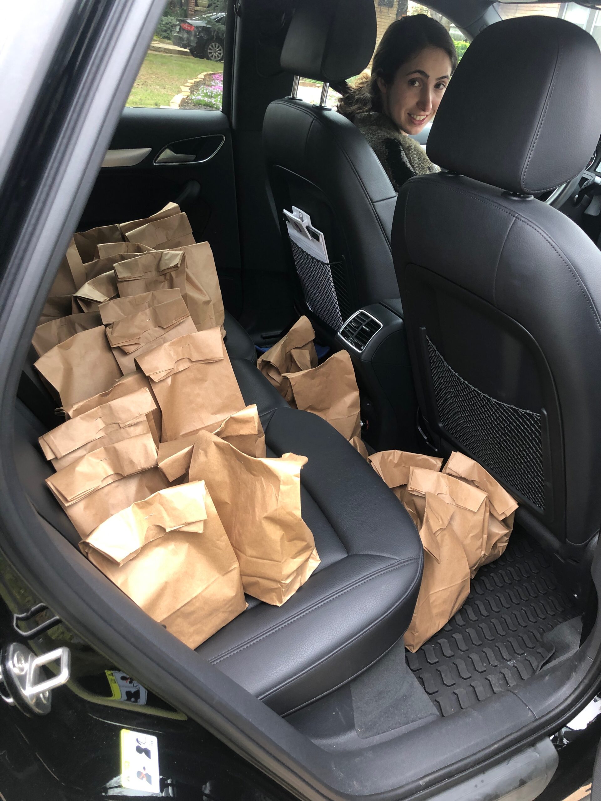 The back of a car full of paper bag sack lunches
